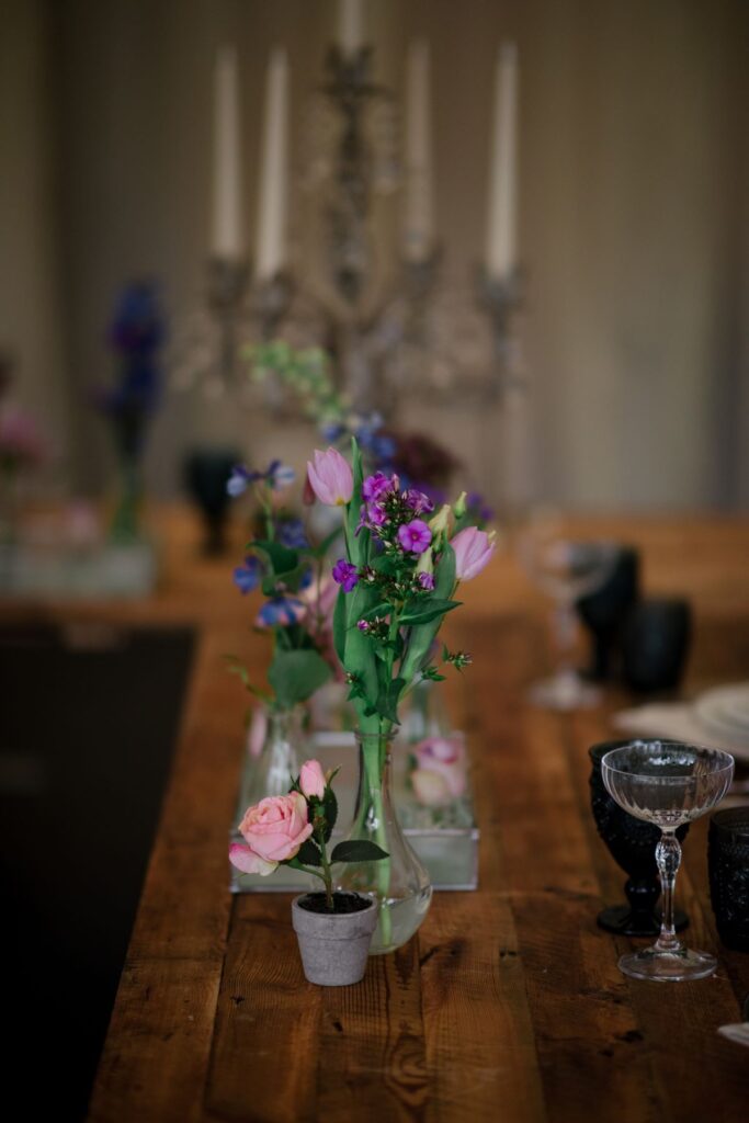 A collection of bud vases form the centre piece of this petite wedding tablescape