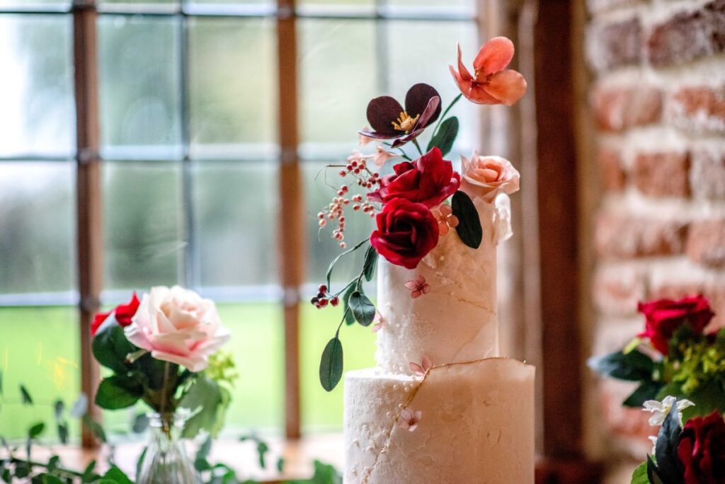 A wedding cake on a window sill