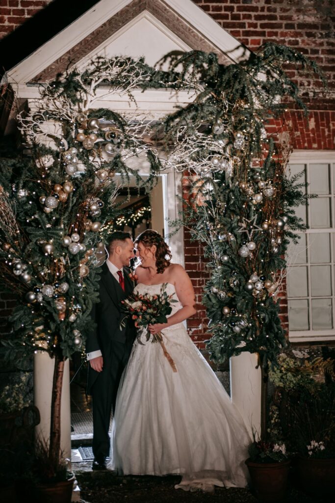 A couple under a floral arch