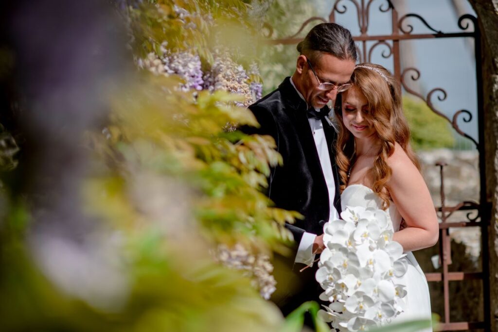 A couple look at a bouquet full of orchids