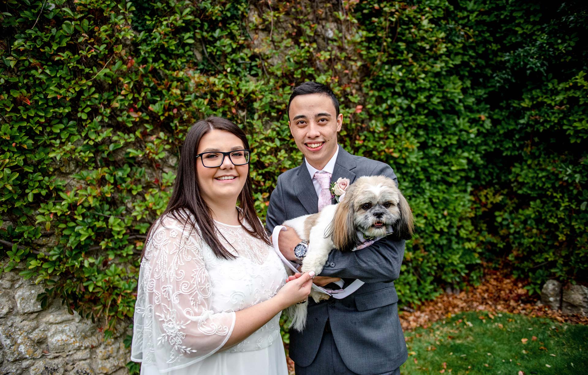 Our happy elopement couple hold their Shih Tzu, Dolly at the Castle Westenhanger in Kent with team E-Lope
