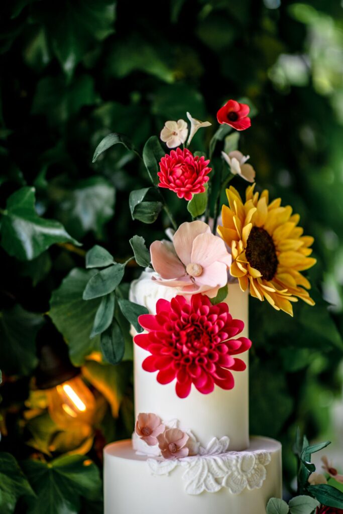 Kirsty and Steve's real elopement at the Castle Westenhanger in Kent by team E-Lope. A wedding cake with sugar flowers including a sunflower by Cobi and Coco