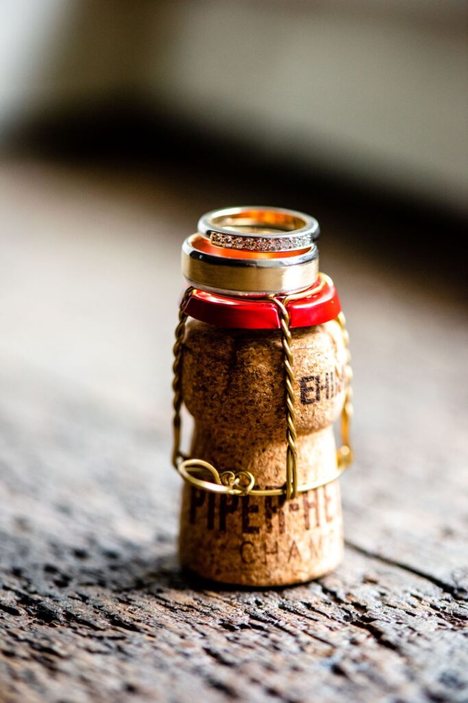 Kirsty and Steve's real elopement at the Castle Westenhanger in Kent by team E-Lope. Steve and Kirsty's wedding rings on a champagne cork
