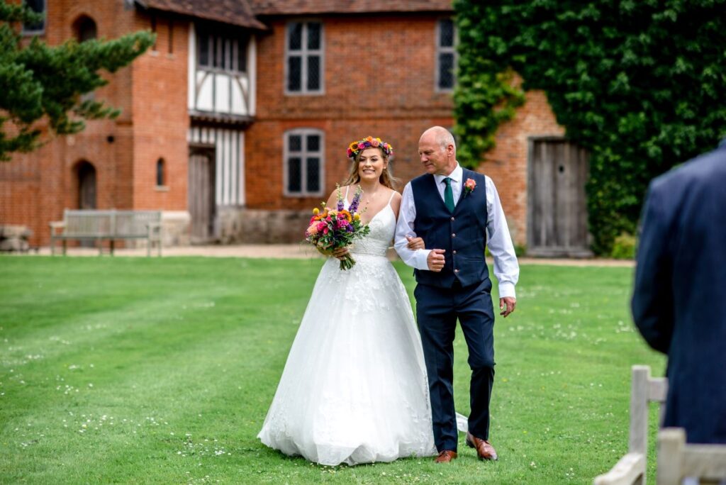 Kirsty and Steve's real elopement at the Castle Westenhanger in Kent by team E-Lope. The bride is walked down the outdoor wedding aisle by her father