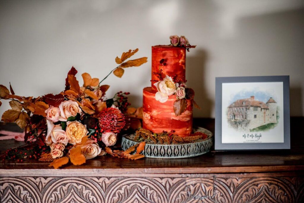 A halloween elopement at the Castle Westenhanger Kent England with an orange wedding cake and bouquet