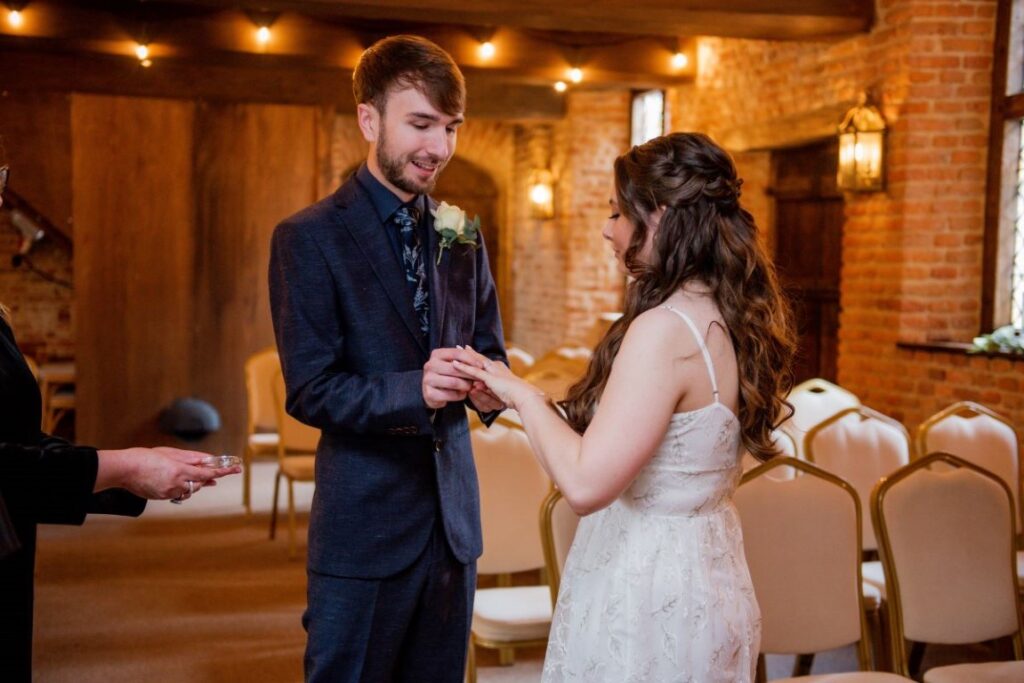 The bride and groom say their vows at the Castle Westenhanger in front of the Kent County Council Official witnesses by team e-lope