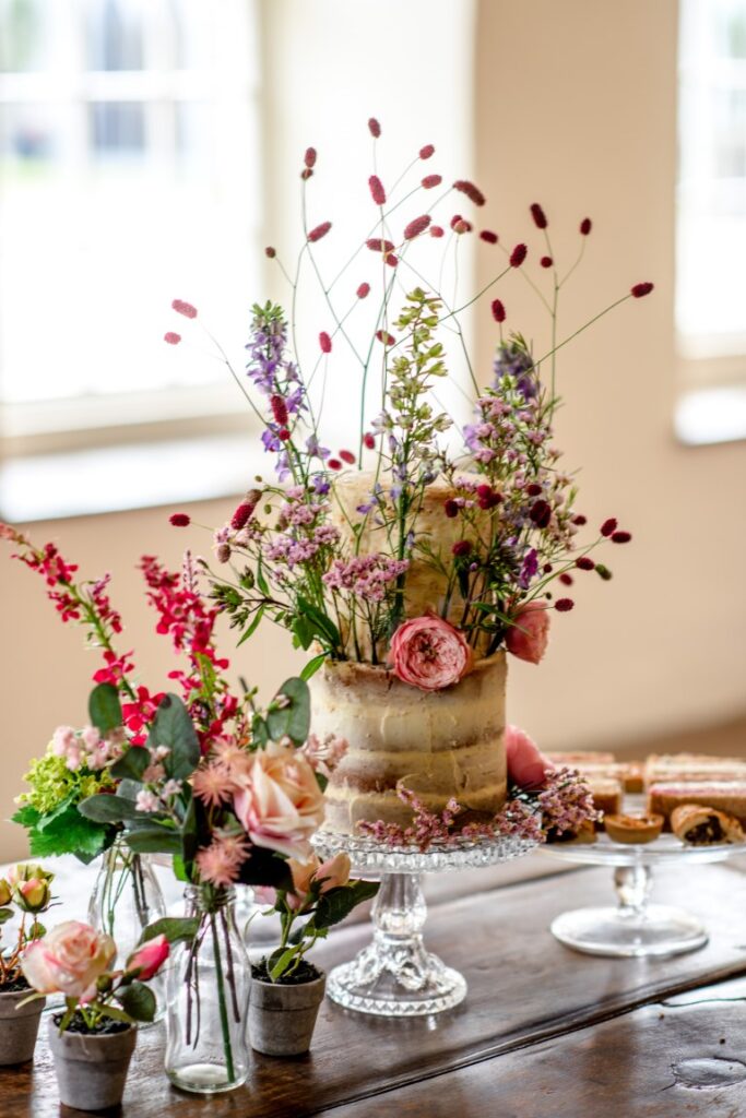 A an elopement cake decorated with real and dried flowers at the castle Westenhanger, Kent