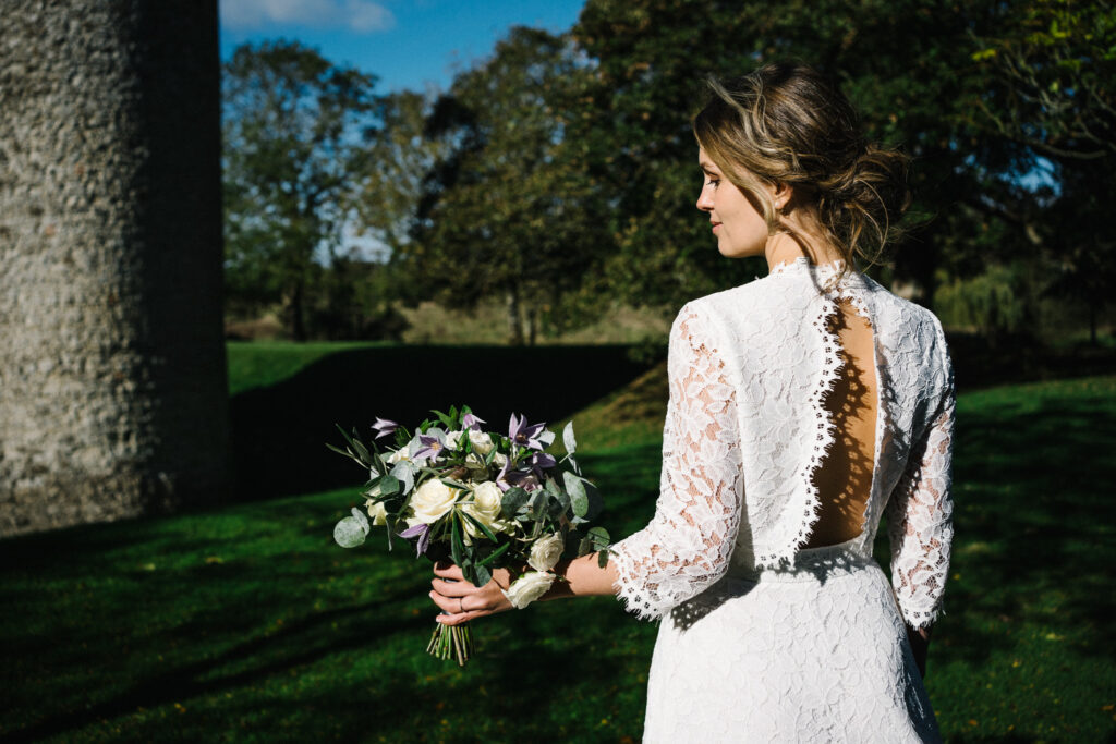 Our bride enjoys looking at her elopement bouquet, at the Castle Westenhanger, created based on her Pinterest board
