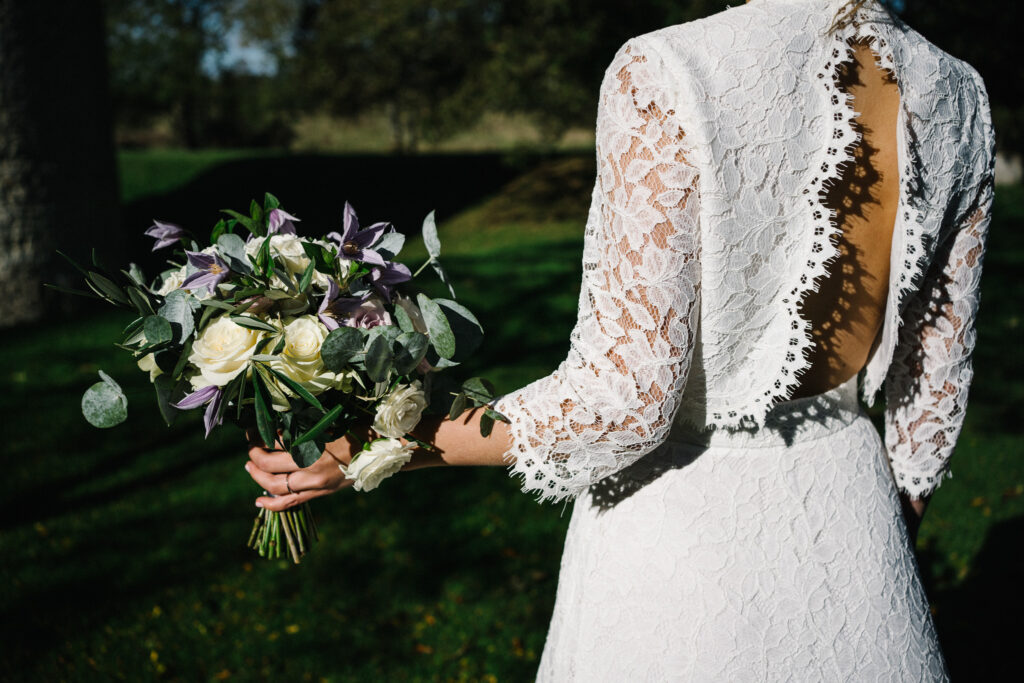 Our bride enjoys looking at her elopement bouquet, at the Castle Westenhanger, created based on her Pinterest board