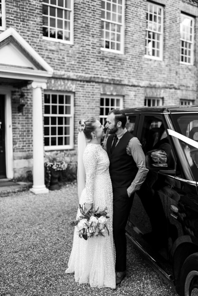 The couple enjoy their private shots in front the fortified 14th Century manor house in Kent leaning against the father-in-laws London Taxi