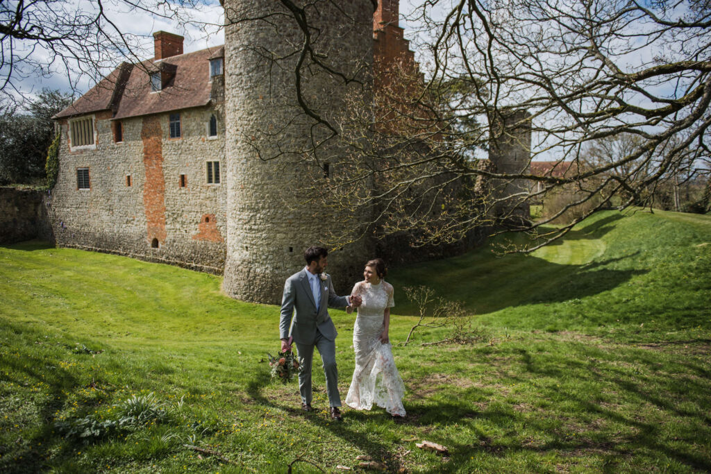 A couople walk infront of the Castle Westenhanger in Kent after eloping