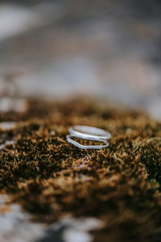 Two wedding rings on a moss covered rock at the Castle Westenhanger in Kent