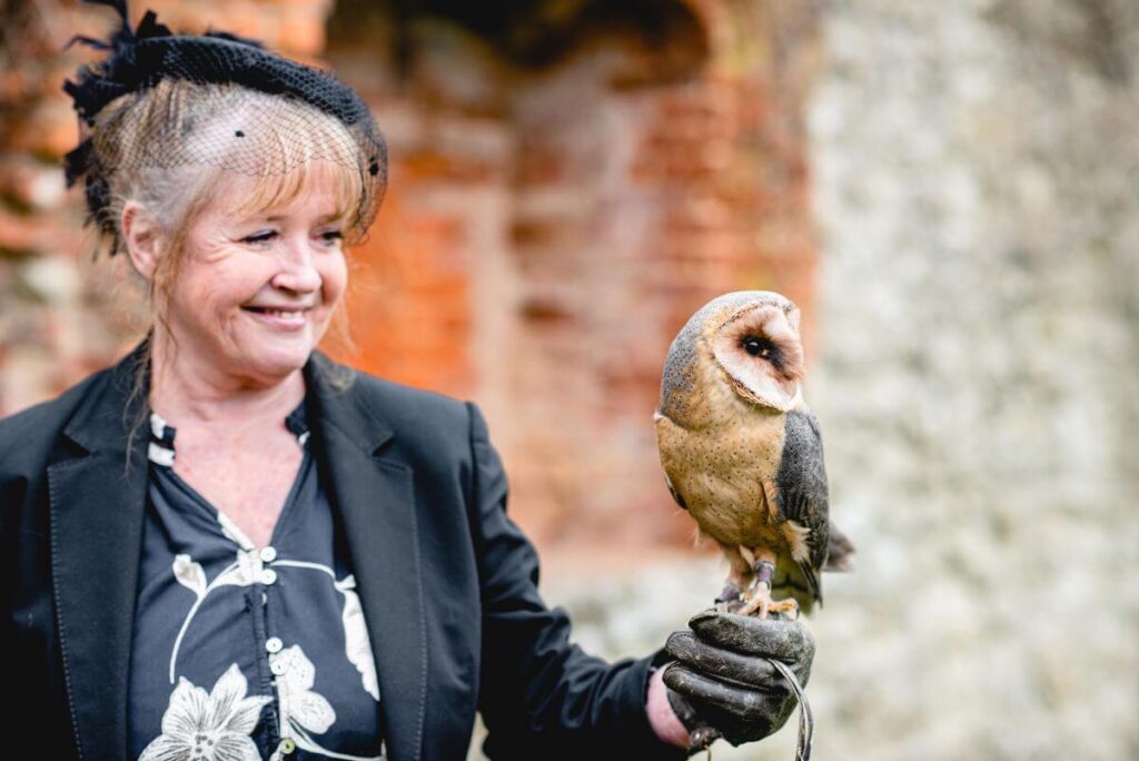 Emma and Paul's purple and red elopement with birds of prey at the Castle Westenhanger in Kent