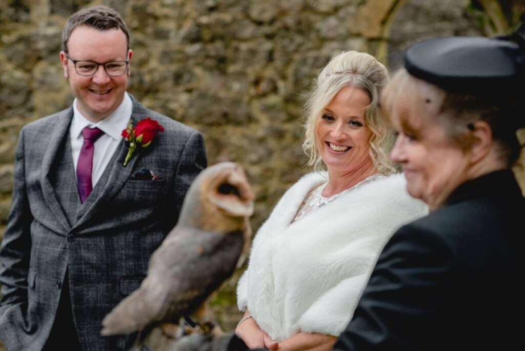 Emma and Paul's purple and red elopement with birds of prey at the Castle Westenhanger in Kent