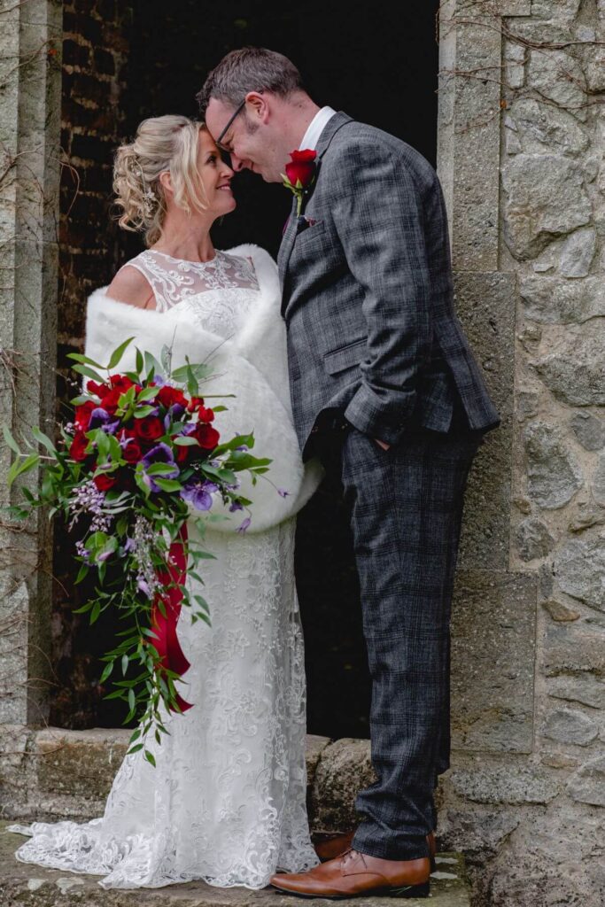 Emma and Paul's purple and red elopement with birds of prey at the Castle Westenhanger in Kent