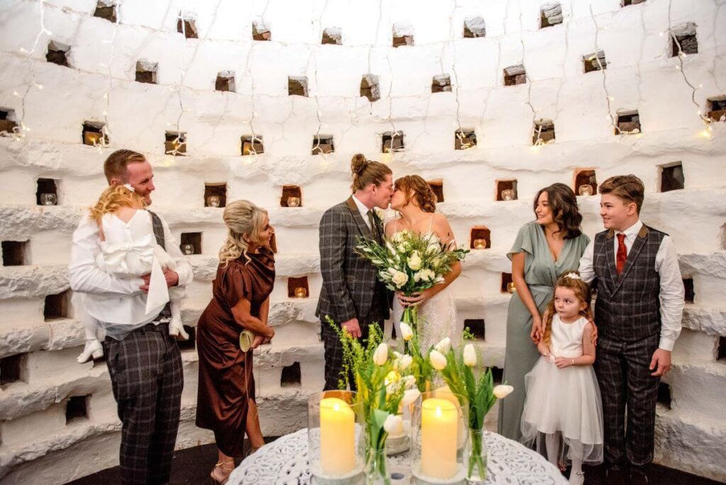 A couple and their family inside the Dovecote at the Castle Westenhanger licenced for tiny, small, micro, petite weddings and elopements