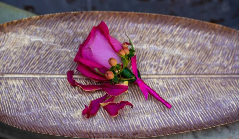 The grooms button hole next to the fountain in the Moroccan Courtyard wihin the mansion at Port Lympne created for a luxury elopement
